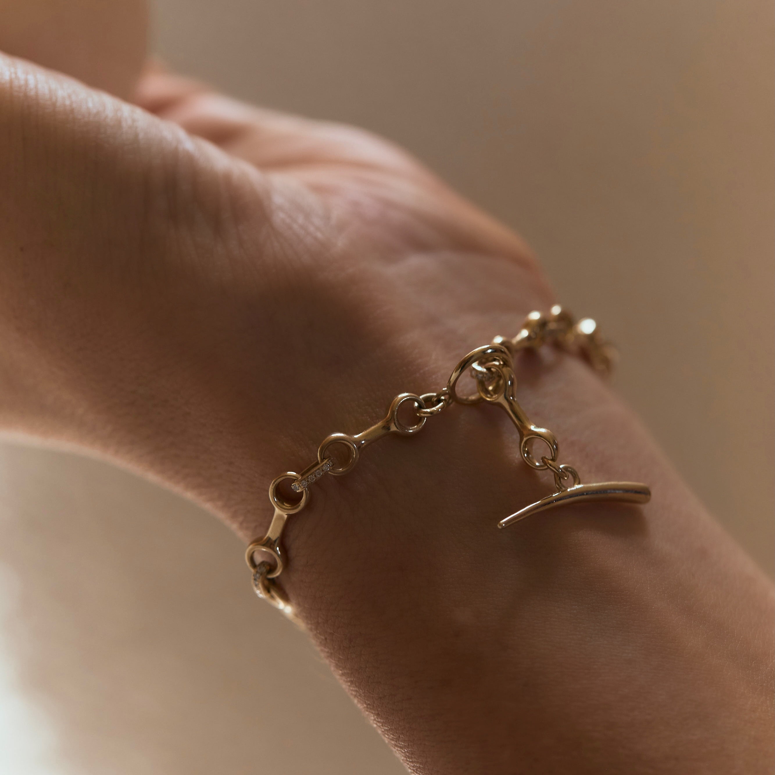 Double Beam Chain Bracelet in 14K yellow gold, with a pave diamond connector binding the beams, offering a bold, diamond jewelry statement - Gabriela Artigas