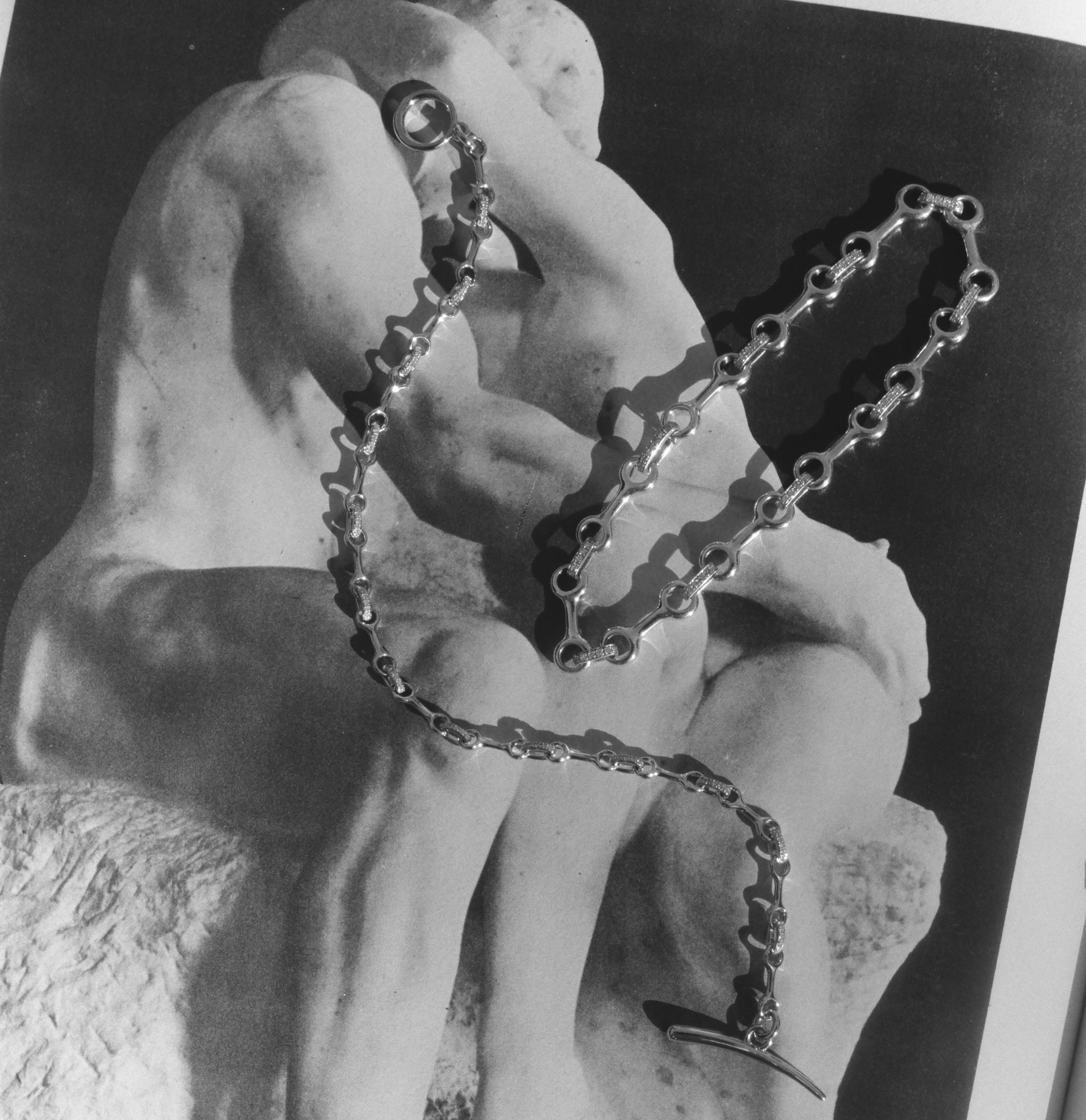 Black and white photograph of a sculpture with a chain draped over it