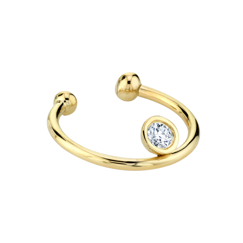 Vermeil gold disc ear cuff featuring a floating diamond, showcasing a modern design- Gabriela Artigas