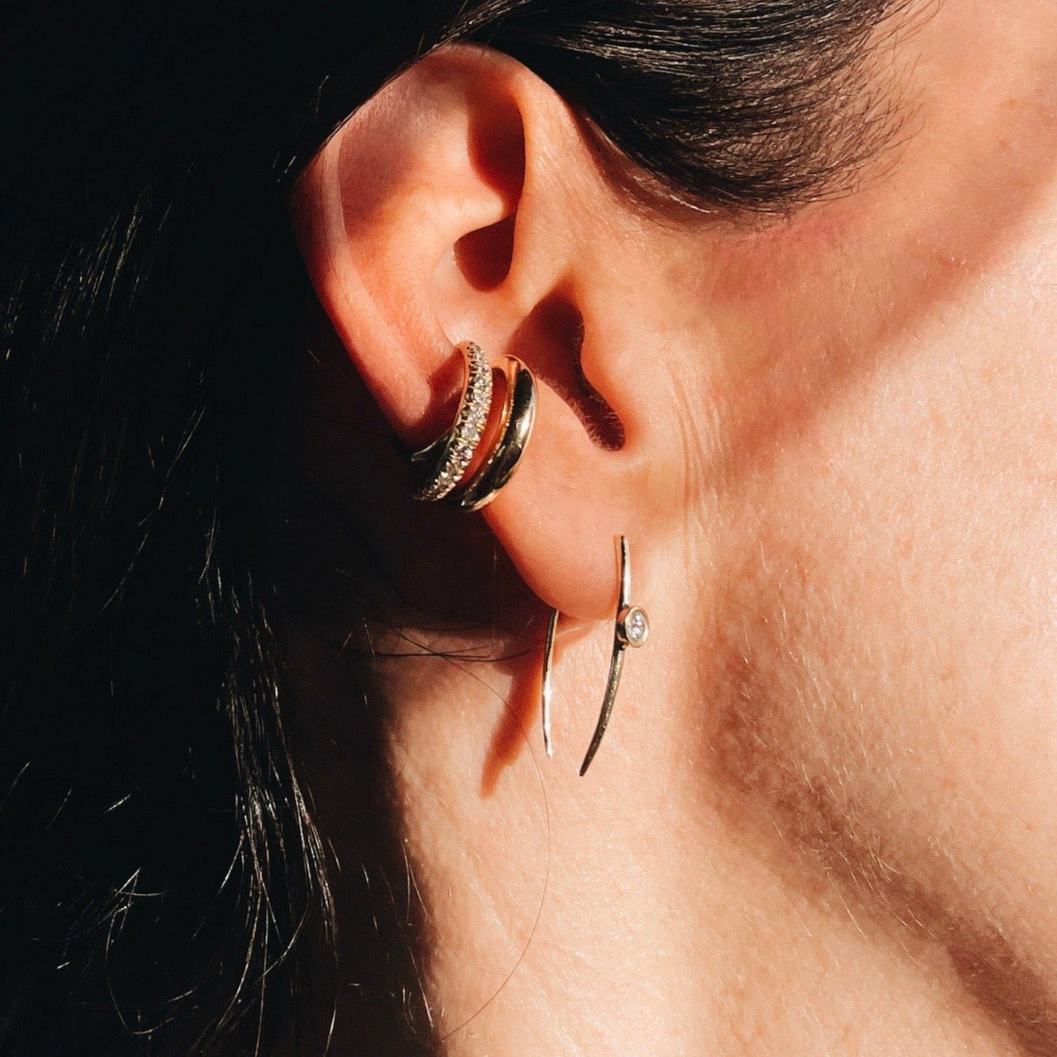 Sleek gold large infinite tusk earrings with a delicate floating diamond detail - Gabriela Artigas