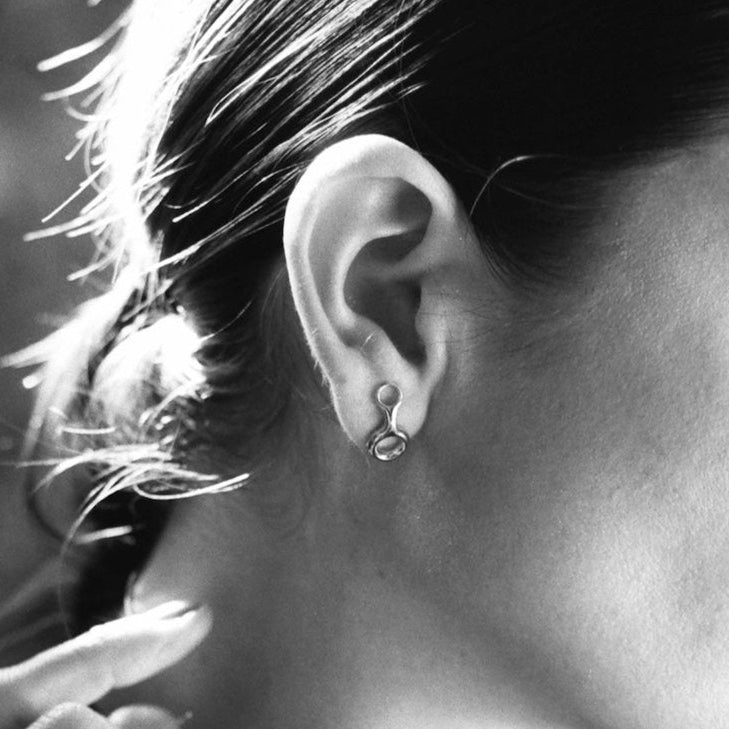 The Ray earrings in 14K Yellow Gold offer a contemporary look with an infinity design and 18mm diameter - Gabriela Artigas