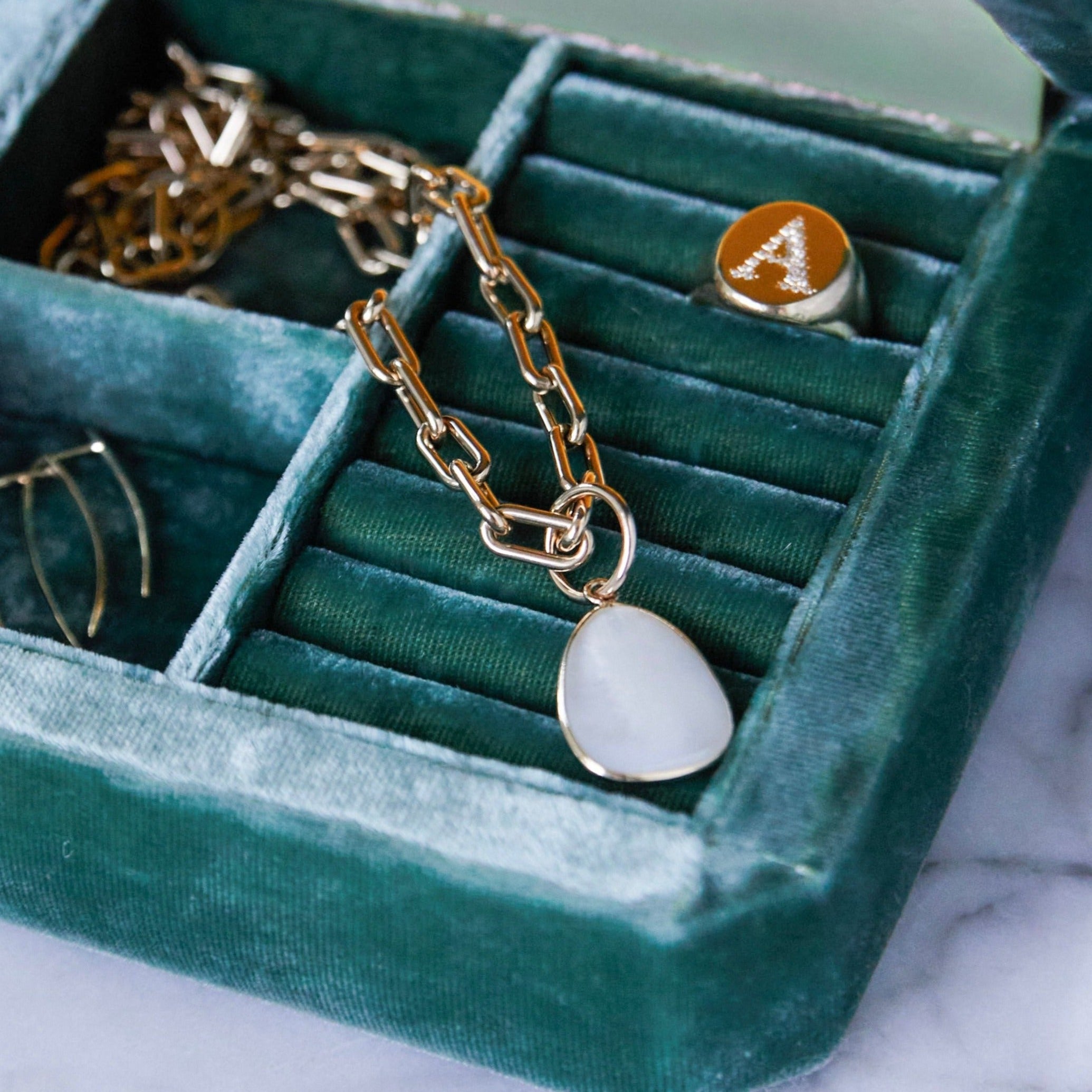 The mother of pearl drop pendant, encased in a sleek 14K yellow gold frame, is designed for compatibility with most chains, creating a refined and versatile jewelry piece - Gabriela Artigas