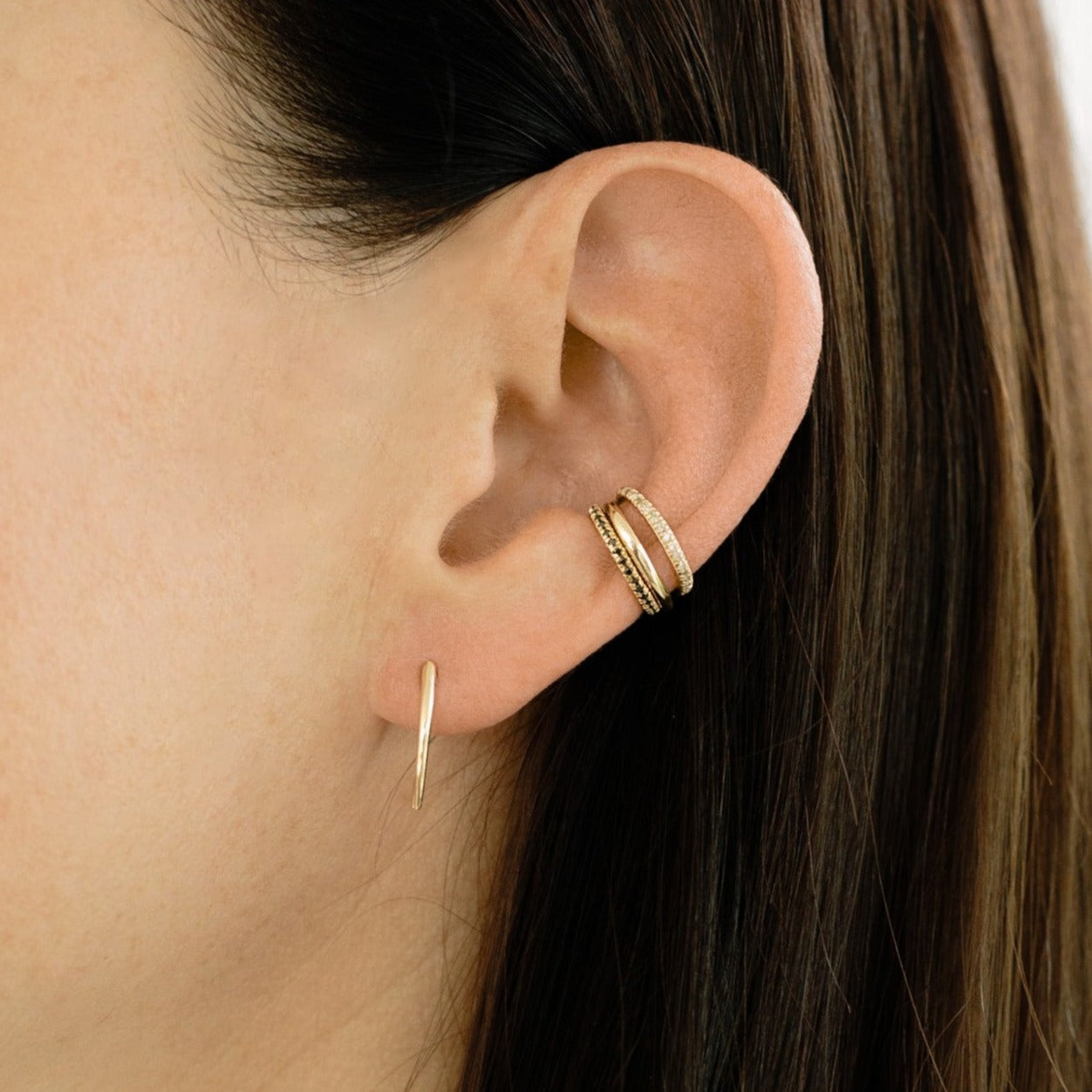 Shimmering white pavé diamonds blanket this yellow gold Infinite Tusk Ear Cuff, a sleek layerable piece for bold ear styling - Gabriela Artigas