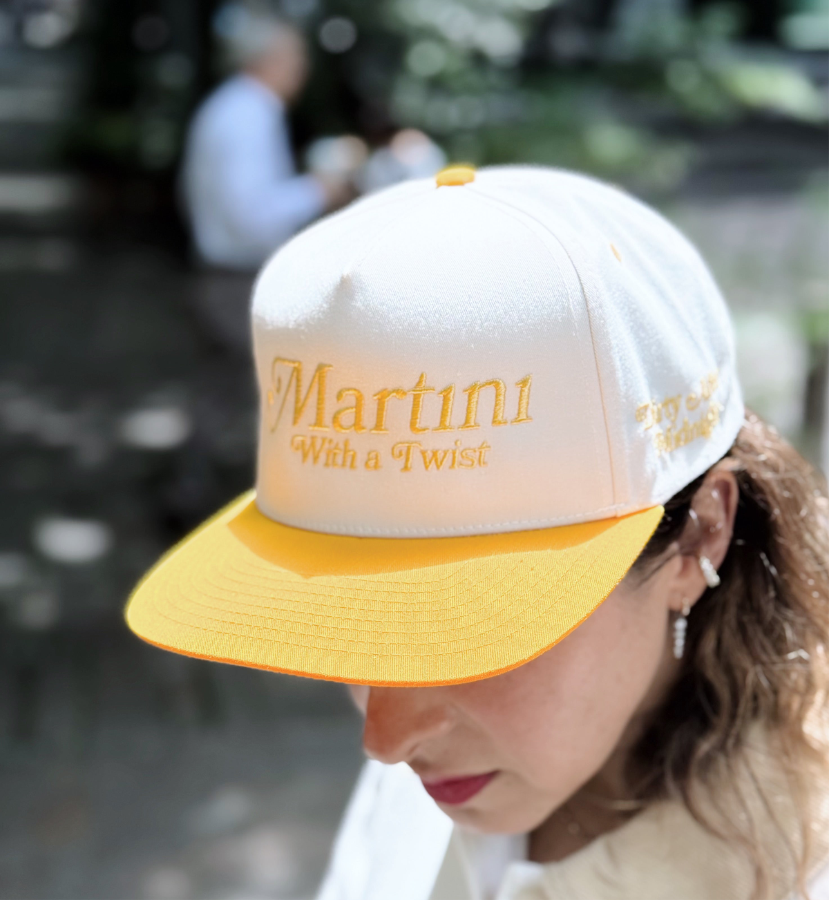 Bold Martini Baseball Cap in white or yellow, featuring "Martini with a Twist on rim and, Dirty after midnight in side" text for a playful, stylish headwear statement - Gabriela Artigas