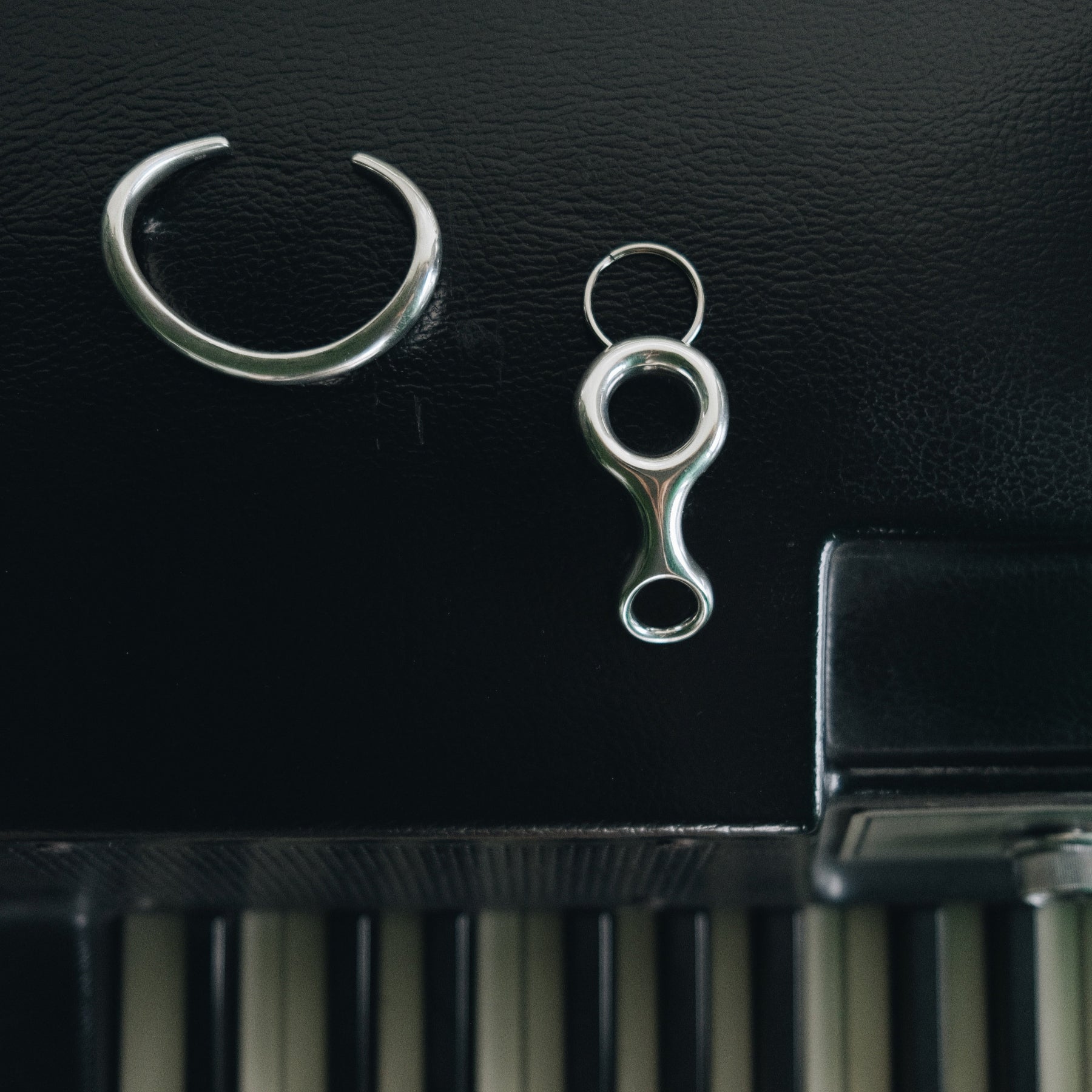 With a nod to Double Beam shapes, the sterling silver plated Ray Key Chain blends sleek architecture with functional luxury - Gabriela Artigas