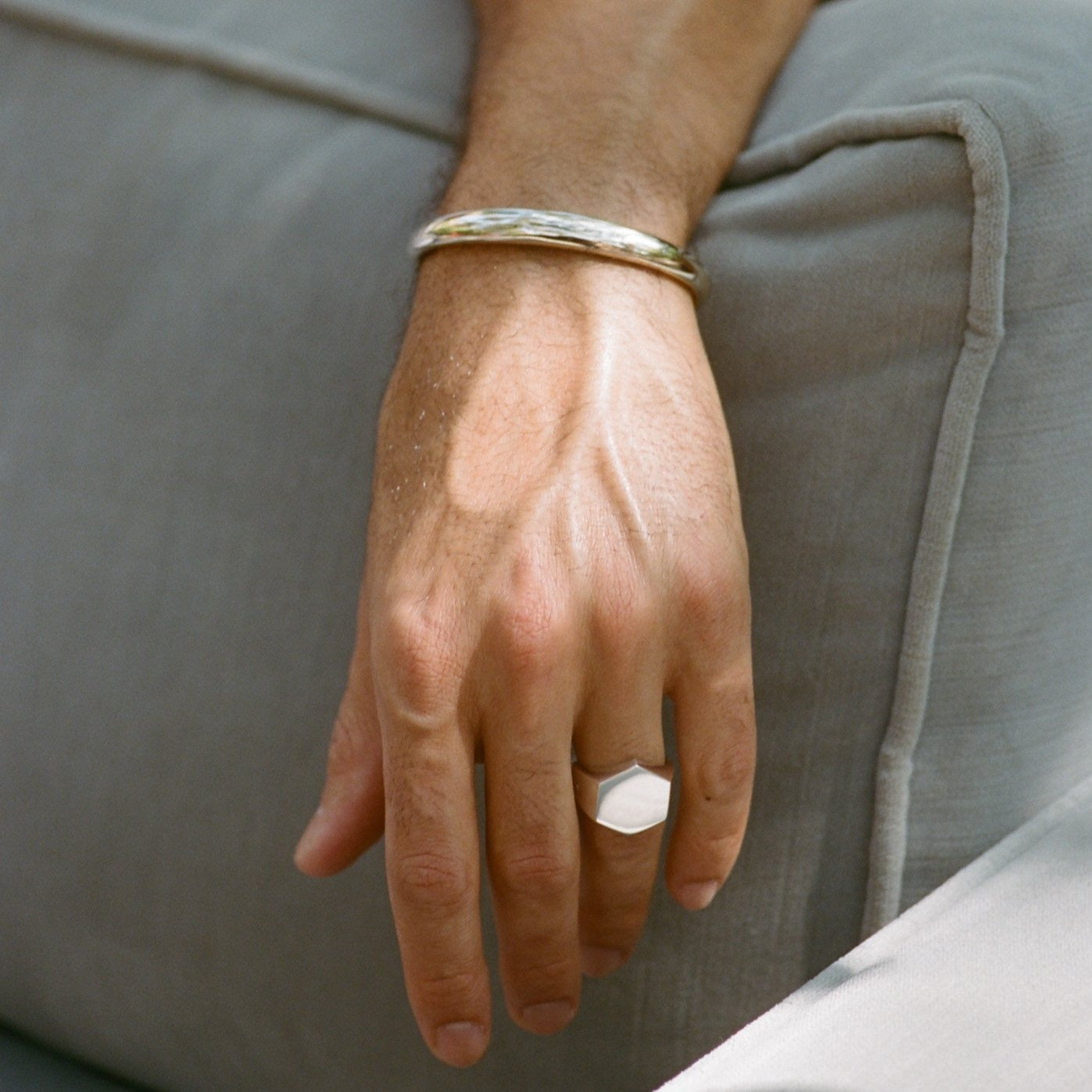A man confidently showcasing a sleek Beam cuff in sterling silver - Gabriela Artigas