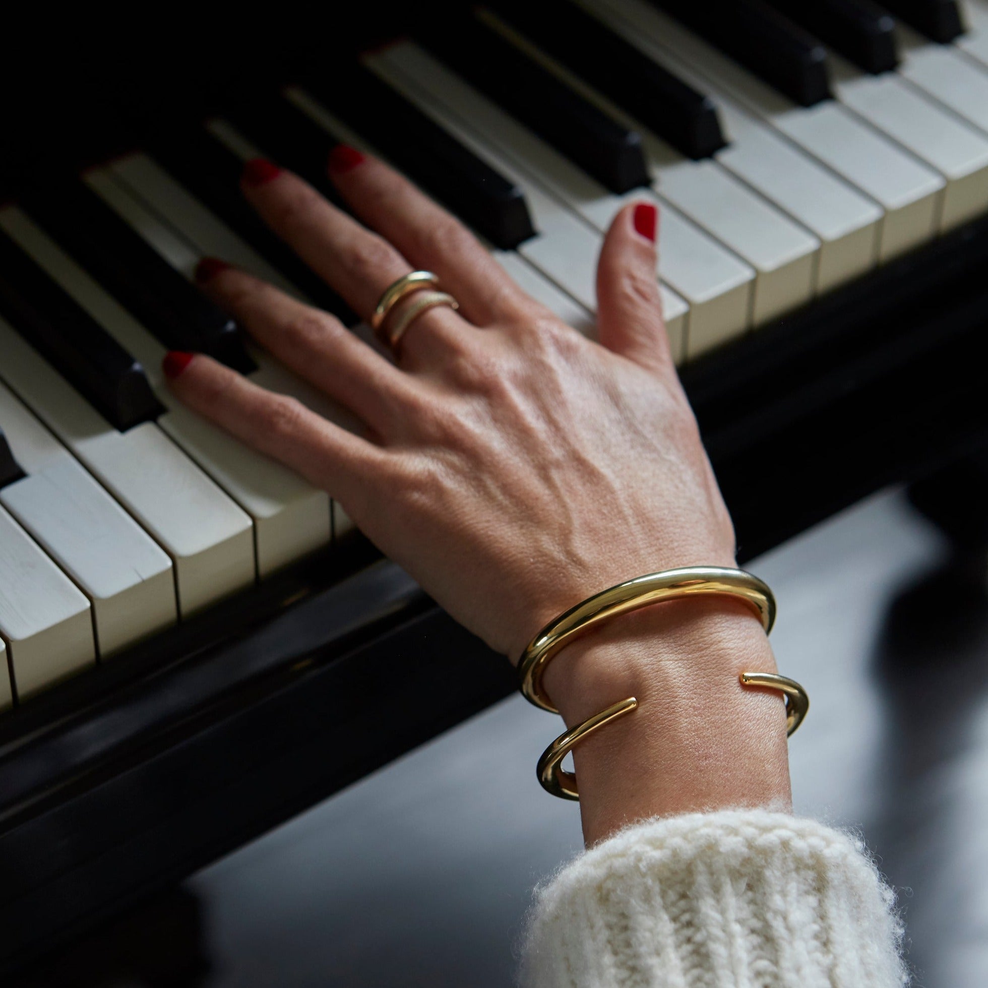 Elegant Infinite Tusk statement cuff, yellow gold plated with a distinctive tapered design, encircling the wrist with artistic grace - Gabriela Artigas