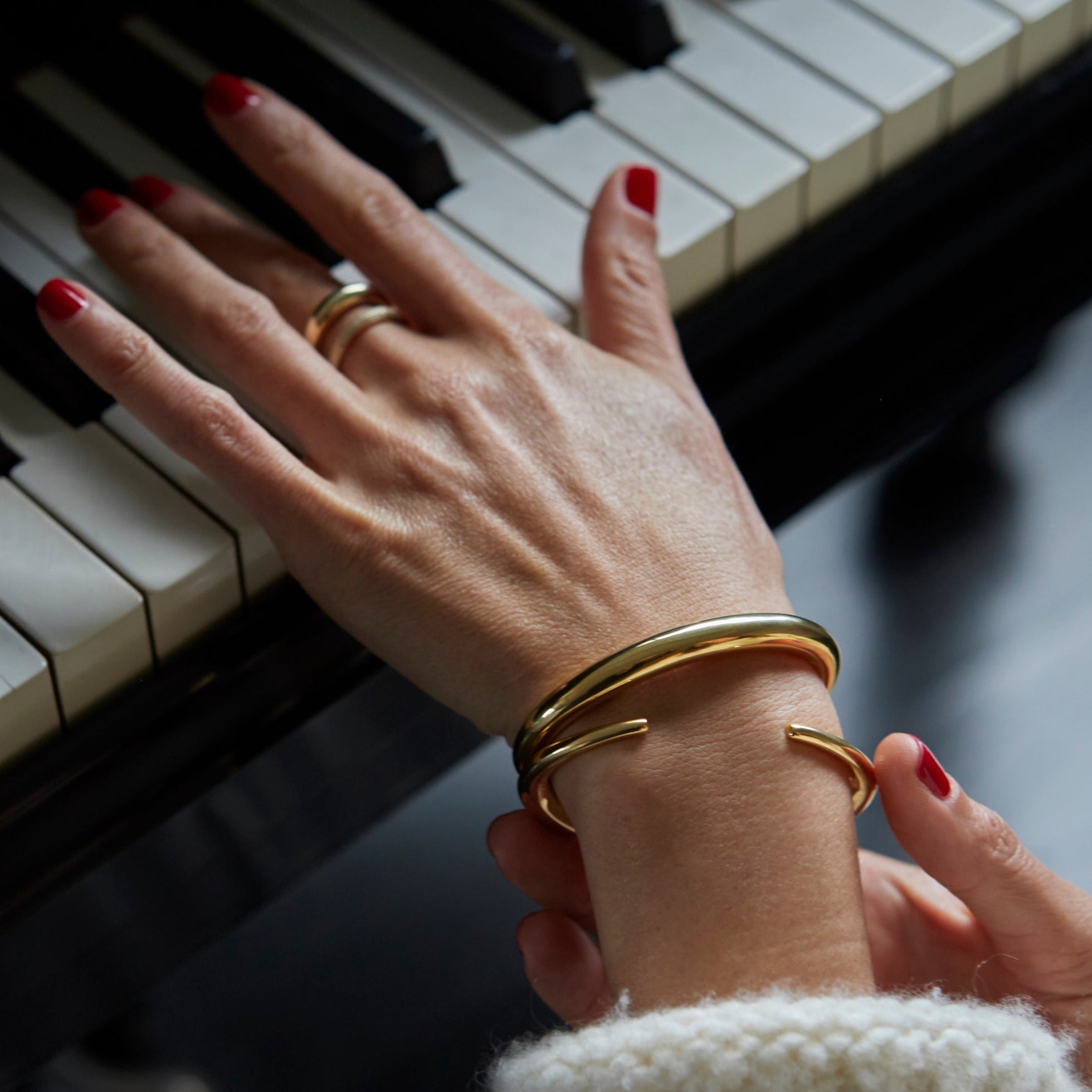 Modern Infinite Tusk gold jewelry cuff, yellow gold plated with a tapered, liquid-like form, crafted for an elegant wrist statement - Gabriela Artigas