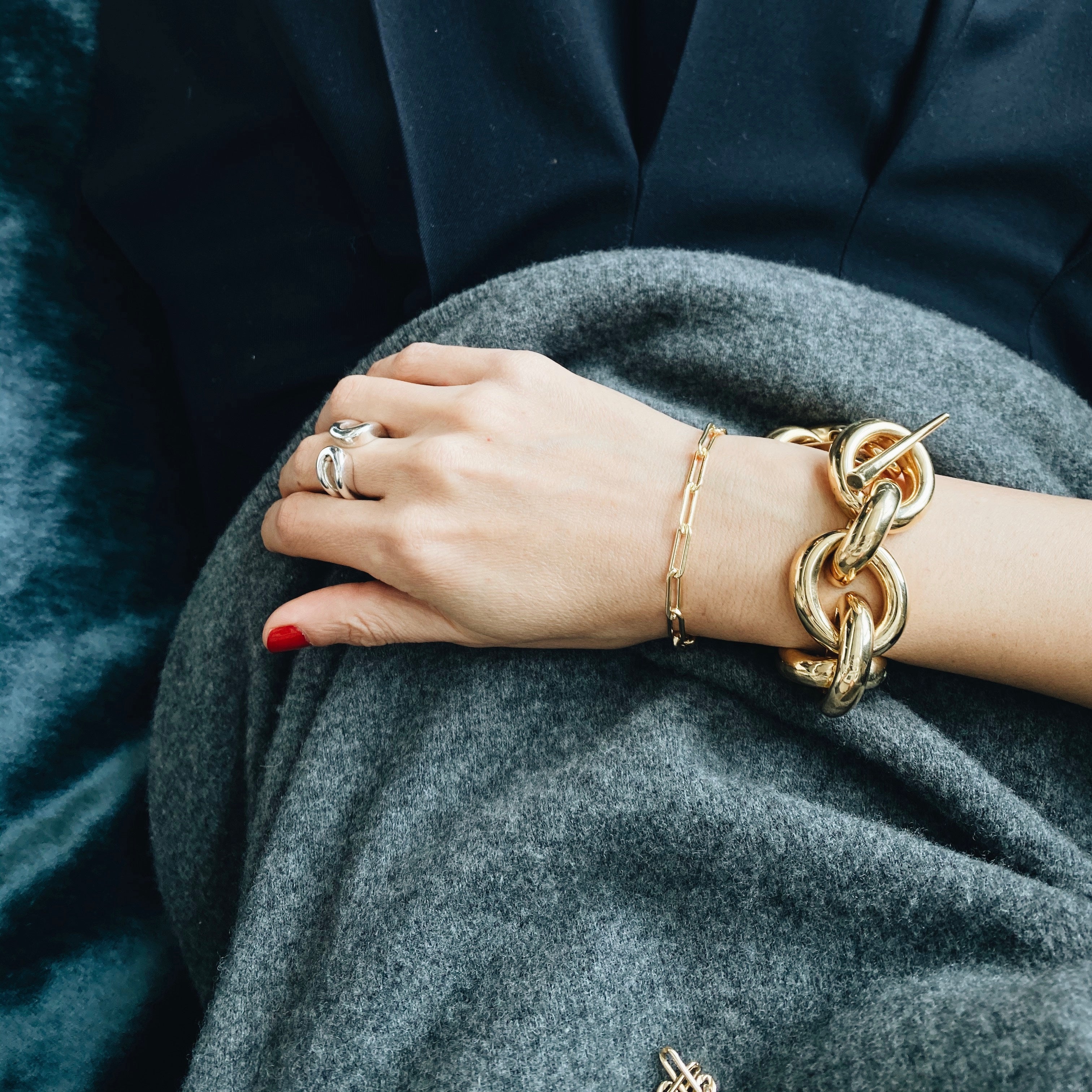 Bold chain bracelet with a dramatic twist and signature Tusk Clasp in yellow gold plating - Gabriela Artigas