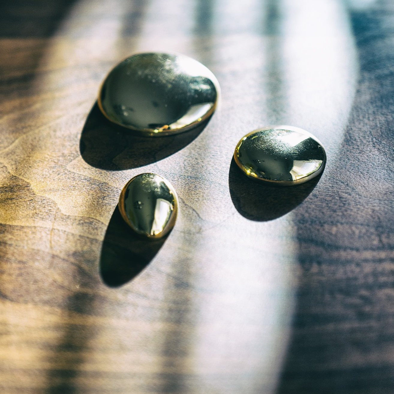 Subtly chic Puddles Paperweights in classic egg and circle forms, designed as functional, modern decor for a refined home aesthetic - Gabriela Artigas