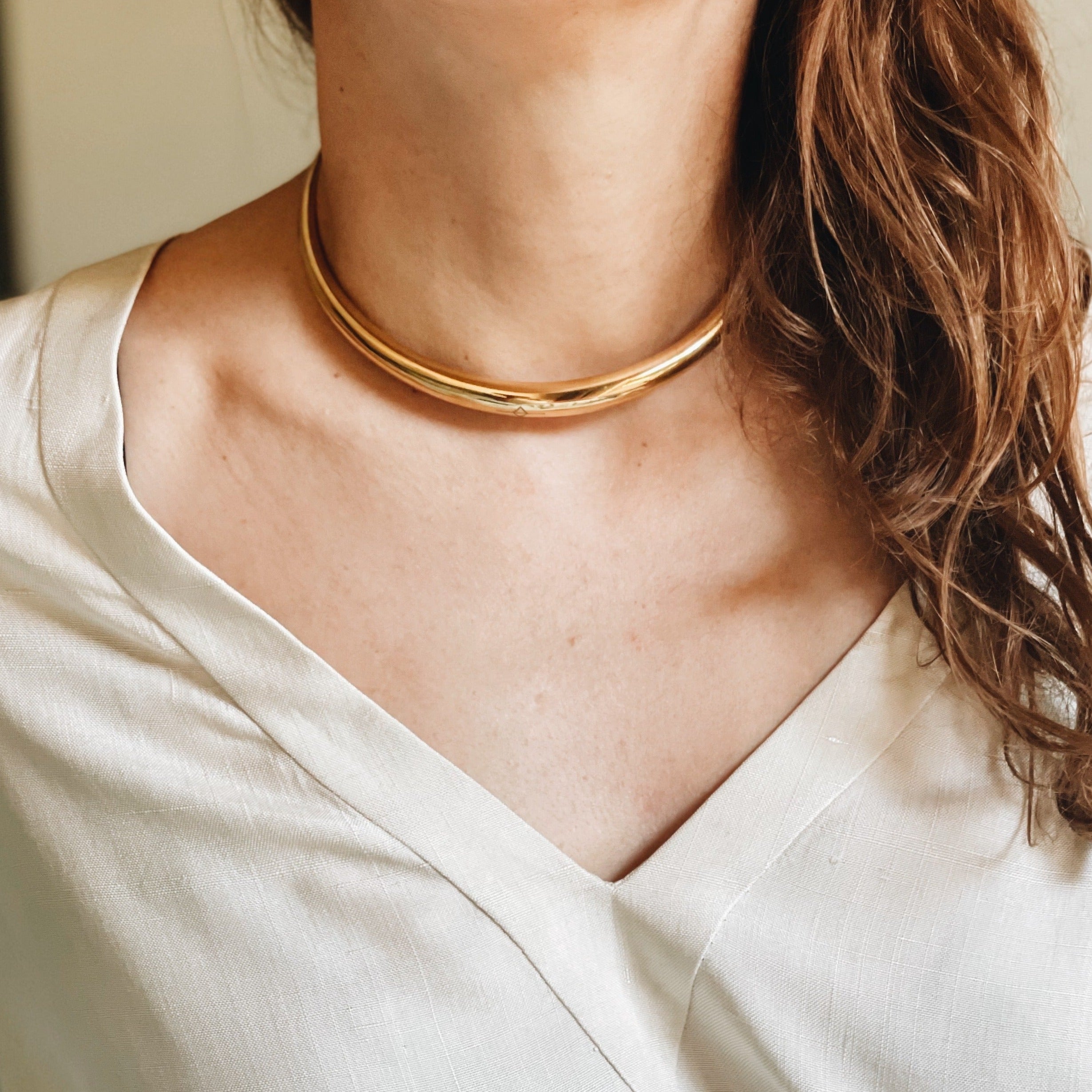 Luxury gold-plated Thick Tusk Solid Choker, sitting chicly at the collarbone, merging the robust Original Infinite Tusk design with the refined elegance of the Tusk Choker for standout style - Gabriela Artigas