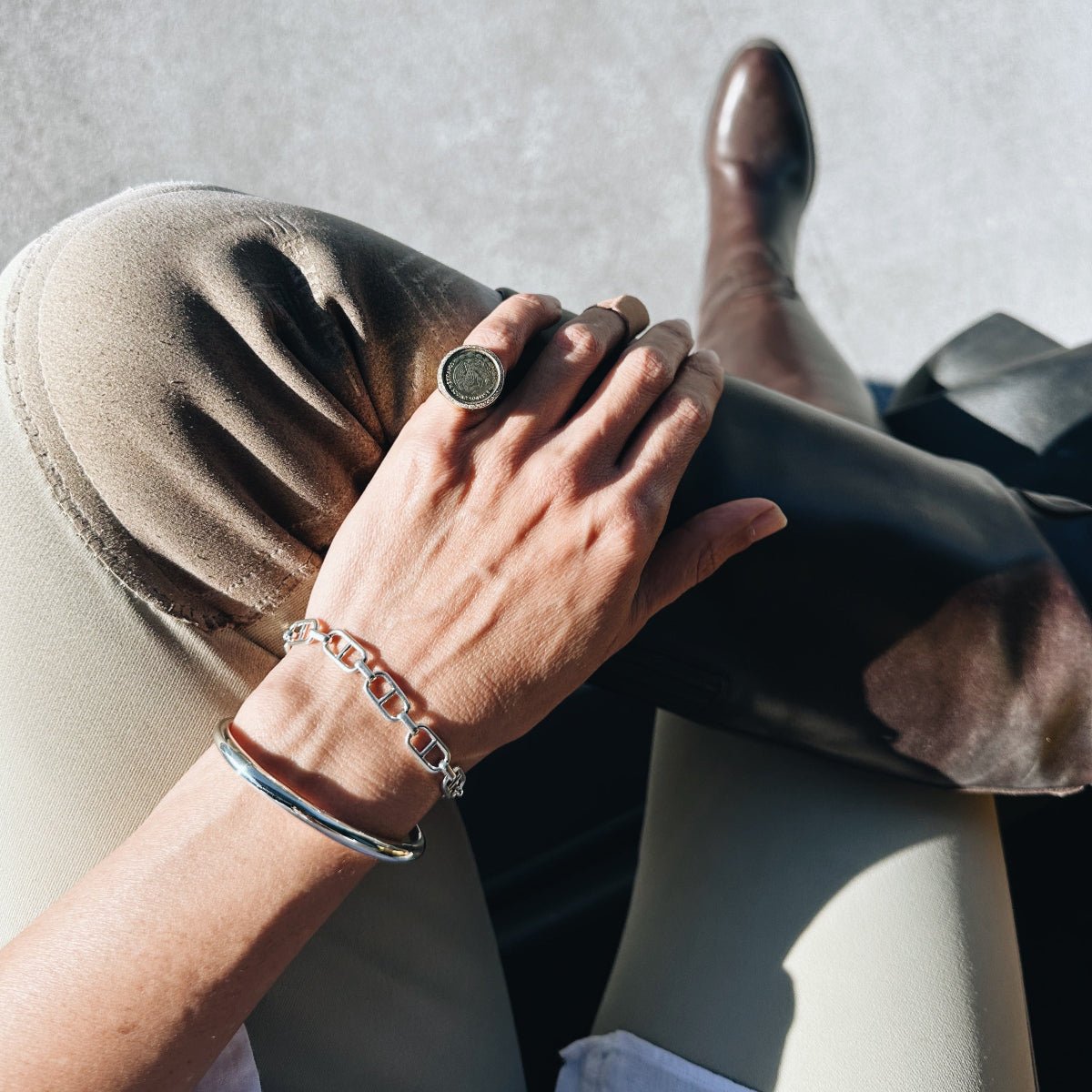 Tusk cuff bracelet, a sculptural cuff that tapers like a tusk - Gabriela Artigas + CO.Stirrup bracelet in silver, inspired by horseback riding, sculptural stirrup chain with signature Tusk Clasp, equestrian-inspired fine jewelry.
Vintage Mexican coin ring with a white pavé diamond border - Gabriela Artigas + CO